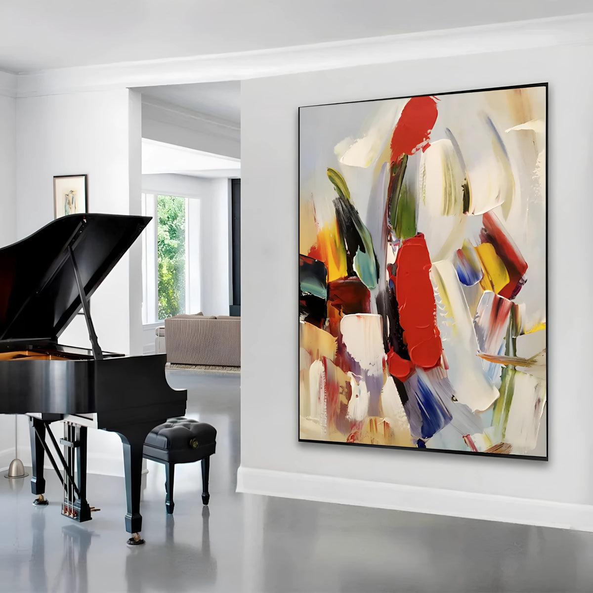 Bold abstract painting with sweeping brushstrokes in red, black, green, and yellow on a soft neutral background, displayed in a modern beige-toned living room.