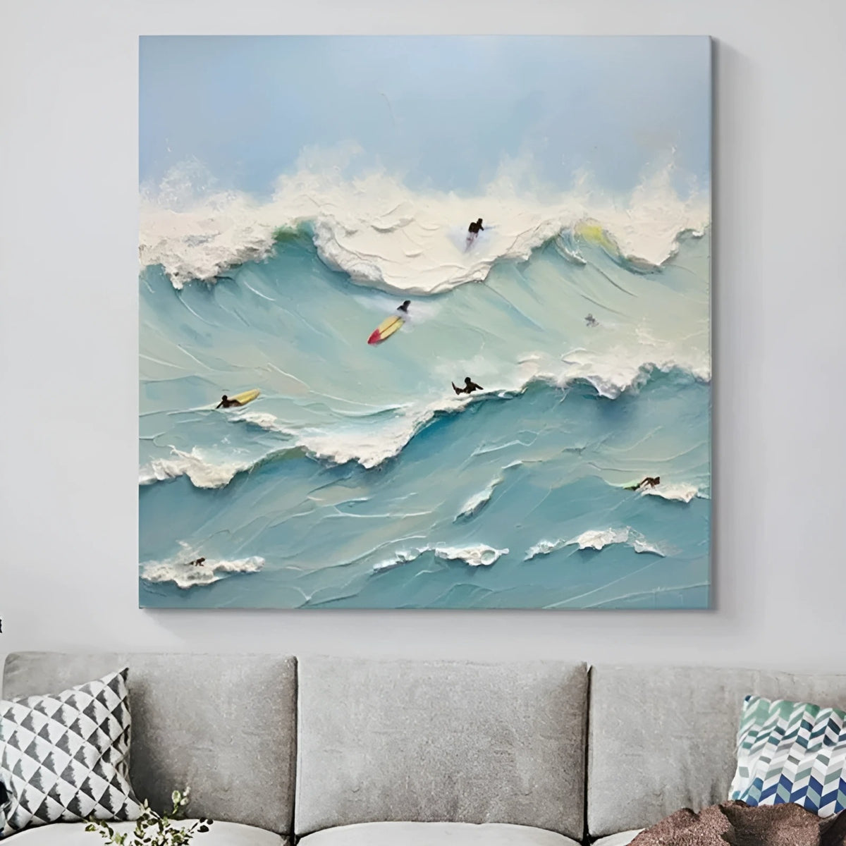 Dynamic wave painting with surfers – A textured painting of surfers riding powerful blue waves under a soft sky, capturing the thrill of the ocean. Perfect for beach-themed or coastal-inspired rooms.