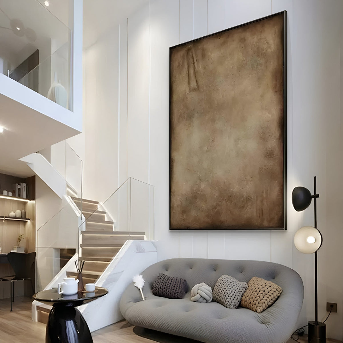 Minimalist abstract painting with earthy brown tones, displayed in a modern living room with neutral décor.